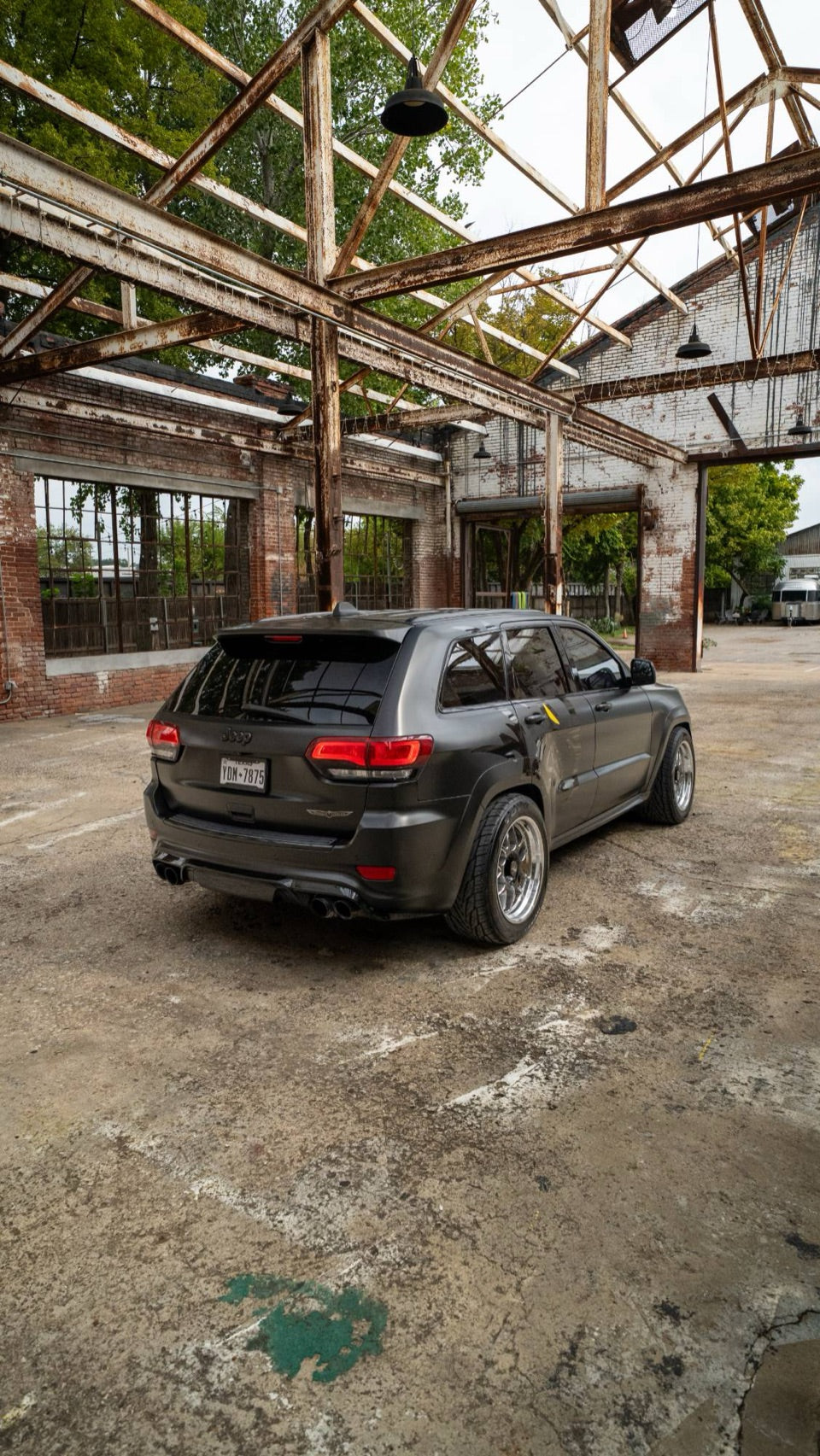 Rear three-quarter view showing the quad exhaust tips
